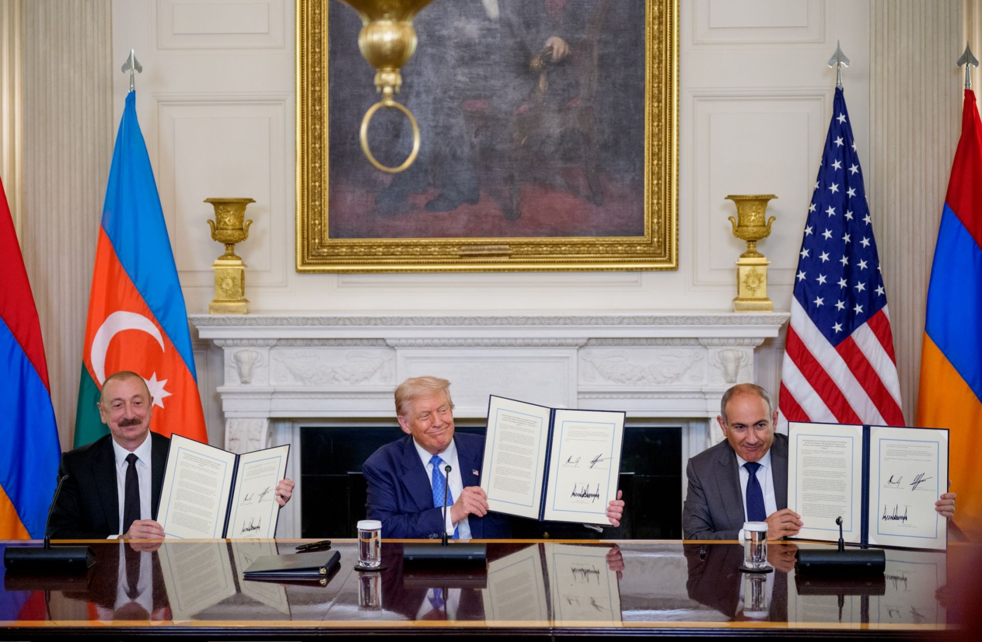 U.S. President Donald Trump (center), Azerbaijani President Ilham Aliyev (left) and Armenian Prime Minister Nikol Pashinyan (right) hold up an agreement signed during a ceremony at the White House on Aug. 8, 2025. U.S. President Donald Trump (center), Azerbaijani President Ilham Aliyev (left) and Armenian Prime Minister Nikol Pashinyan (right) hold up an agreement signed during a ceremony at the White House on Aug. 8, 2025.