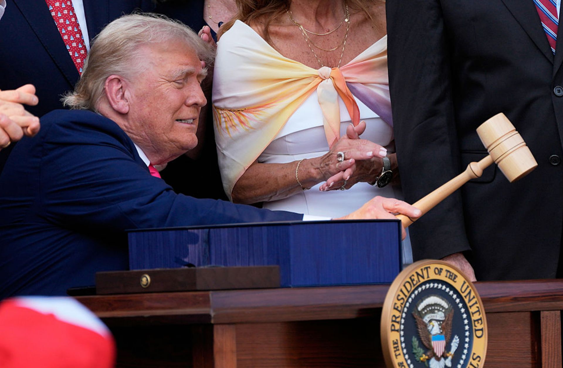 President Donald Trump bangs a gavel after signing a bill into law extending his 2017 tax cuts on July 4 in Washington.