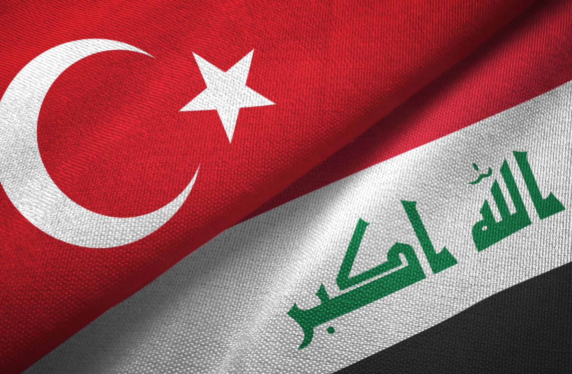 Iraq and Turkey's flags together on a textile cloth fabric 