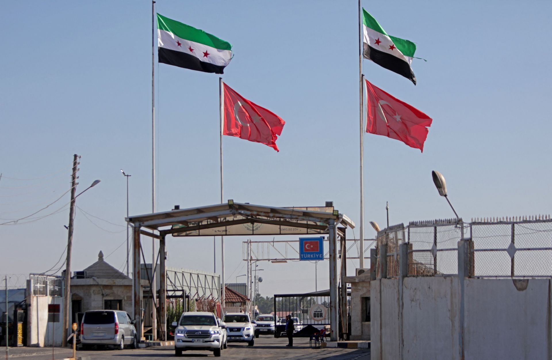 Turkish and Syrian flags wave above Syria's al-Salameh border crossing with Turkey on Aug. 27, 2023. 