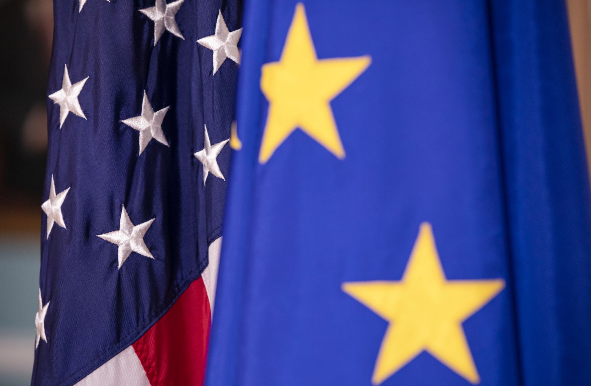 The U.S. and EU flags are seen next to each other.