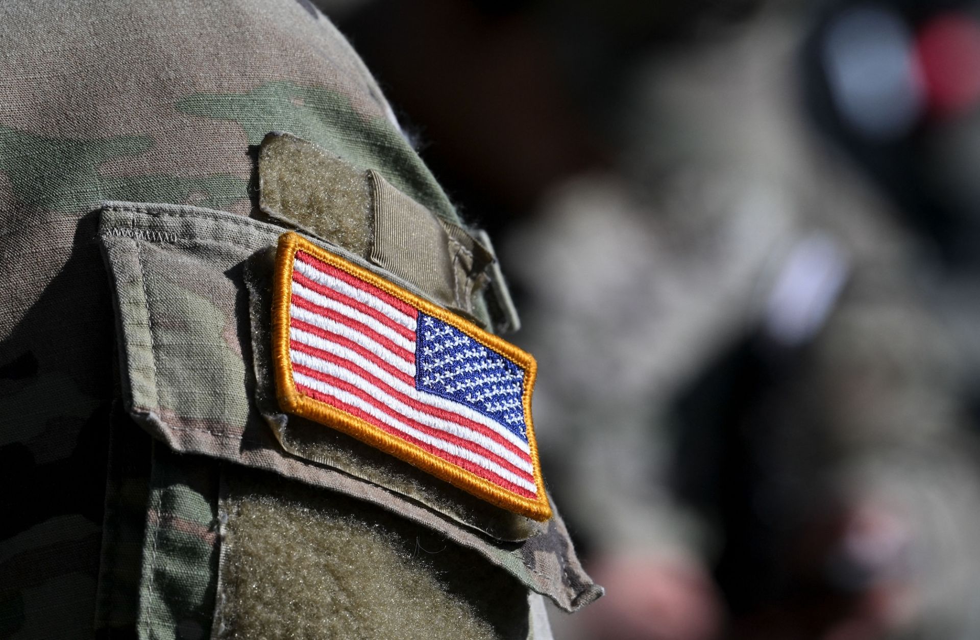 A U.S. flag is pictured on a soldier's uniform at the United States Army military training base in Grafenwoehr, southern Germany, on March 11, 2022.