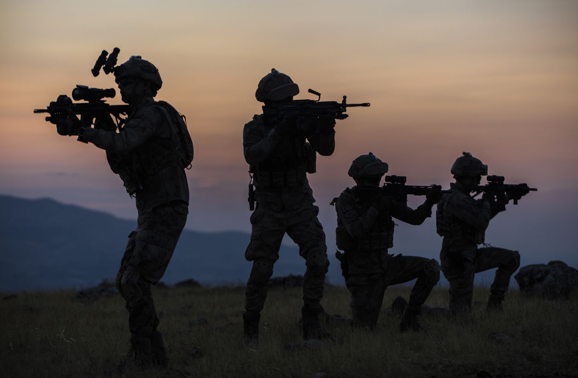 A stock image shows the silhouettes of soldiers.