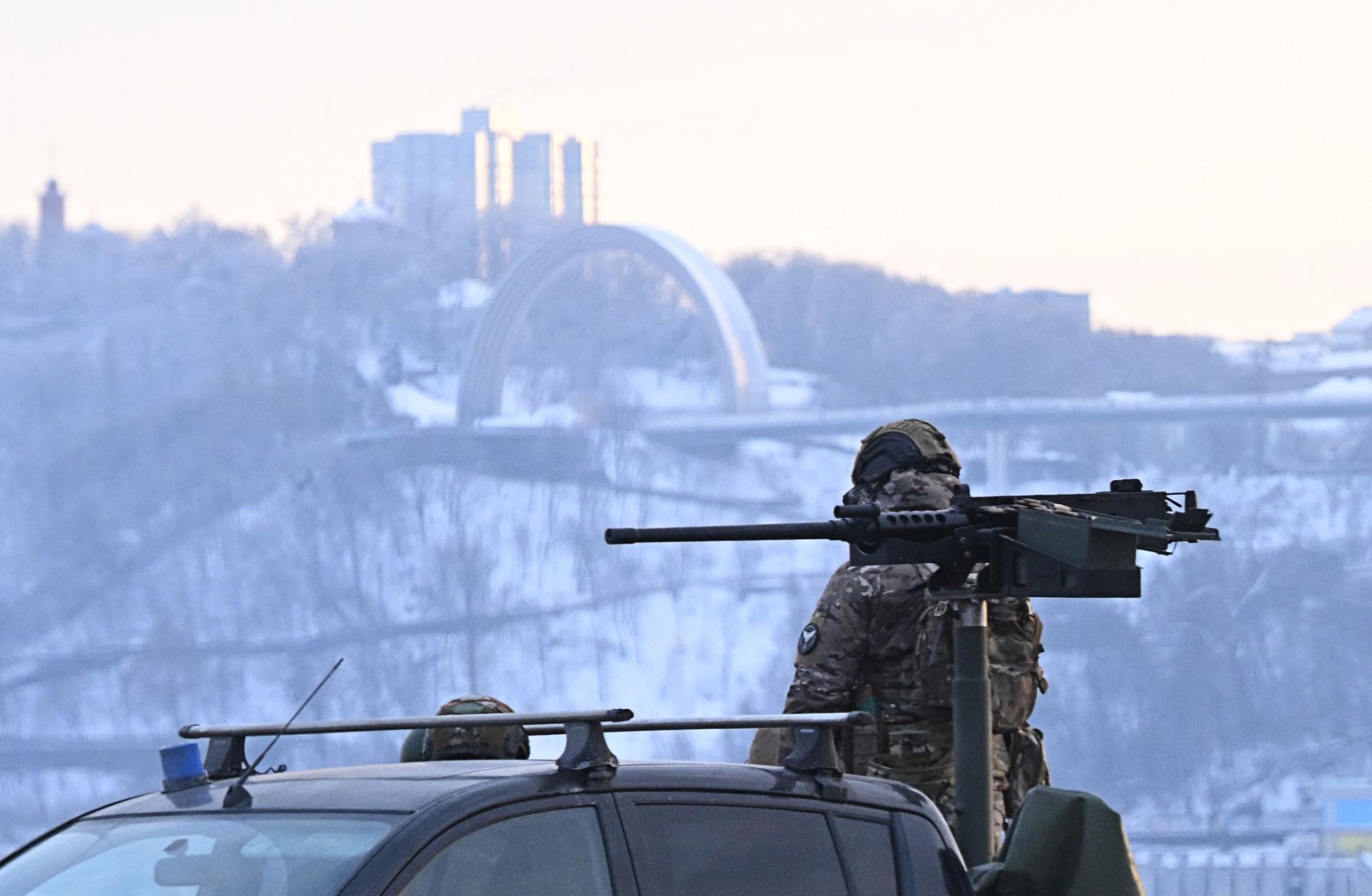A Ukrainian serviceman stands next to a truck equipped with a machine gun during an air raid alert in Kyiv on Jan. 24, 2026, amid Russia’s ongoing invasion.