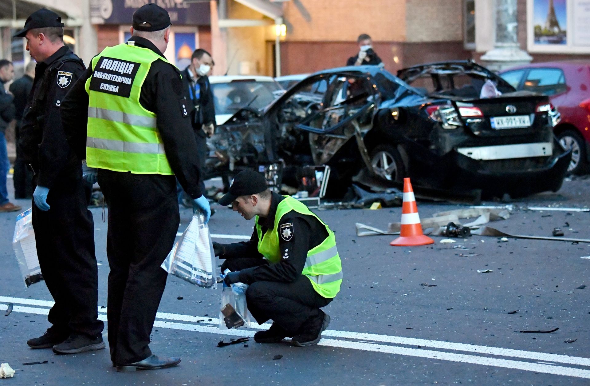 Two Ukrainian police officers investigate a car bombing in Kiev.