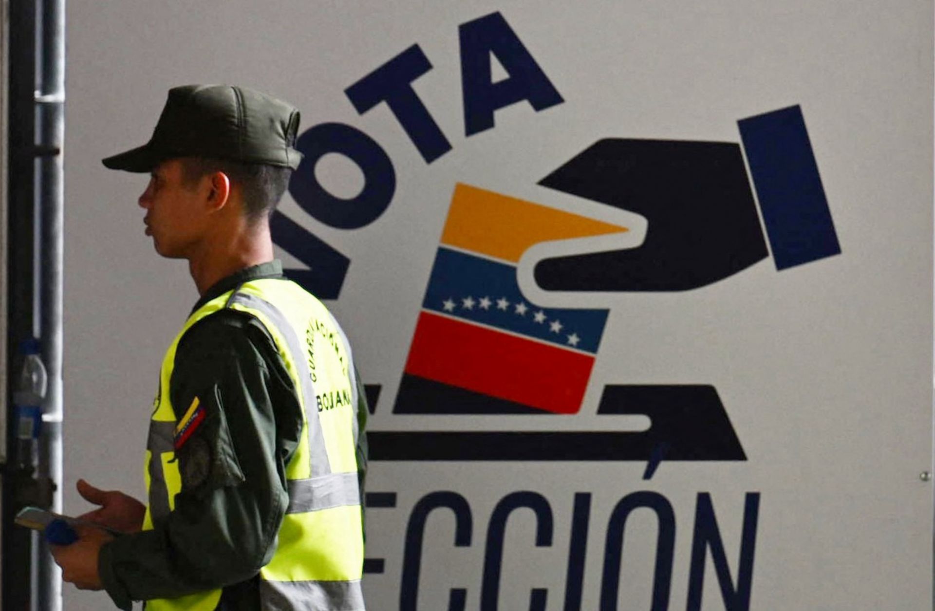 A member of Venezuela’s national guard walks past the information center of the country’s National Electoral Council (CNE) in Caracas on July 16, 2024, ahead of the upcoming presidential election.