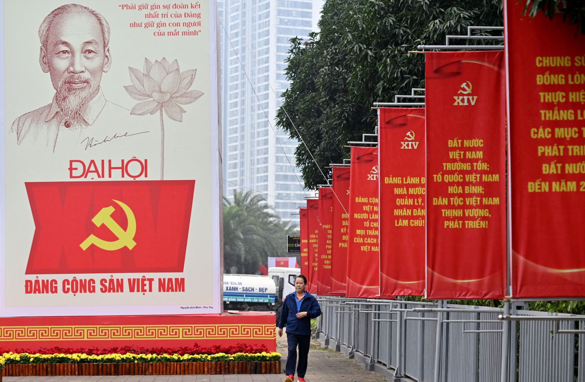A man walks past a billboard for the 14th Congress of the Communist Party of Vietnam outside the National Convention Center in Hanoi on Jan. 15, 2026. 