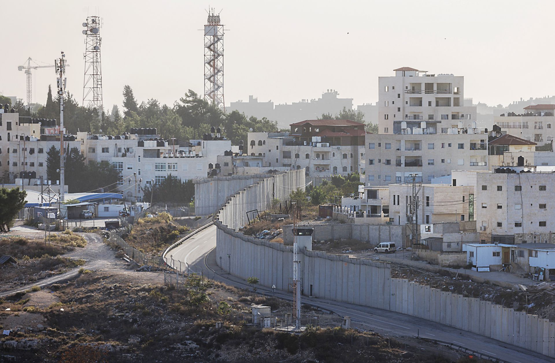 A photo taken on Nov. 4, 2023, shows a wall dividing the West Bank (right) from Israeli settlements (left) in Al-Ram, West Bank.