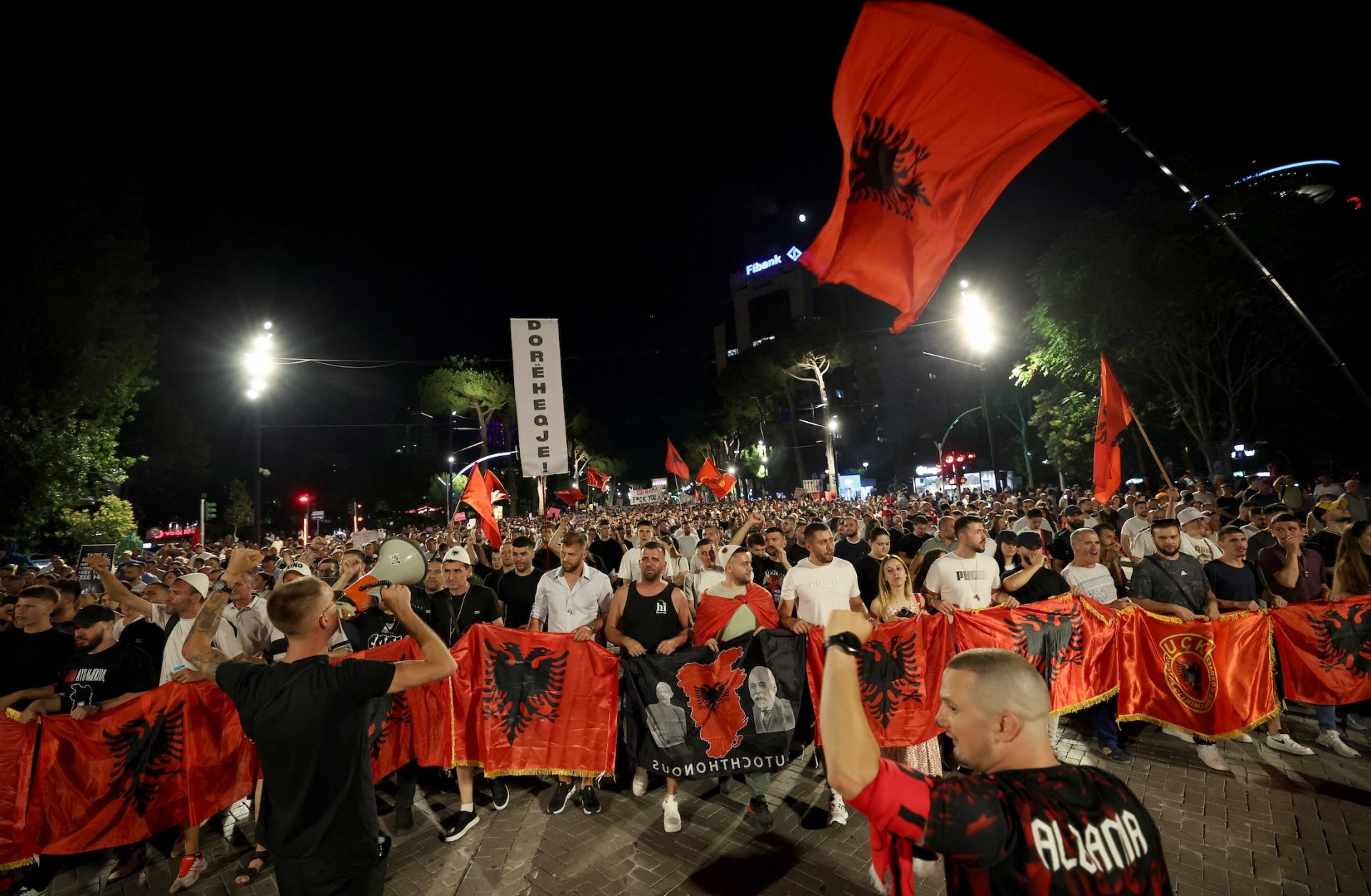 Protestors hold national flags as they gather outside Albania's prime minister's office to oppose the construction of luxury resorts, in Tirana on June 25.Protestors hold national flags as they gather outside Albania's prime minister's office to oppose the construction of luxury resorts, in Tirana on June 25.