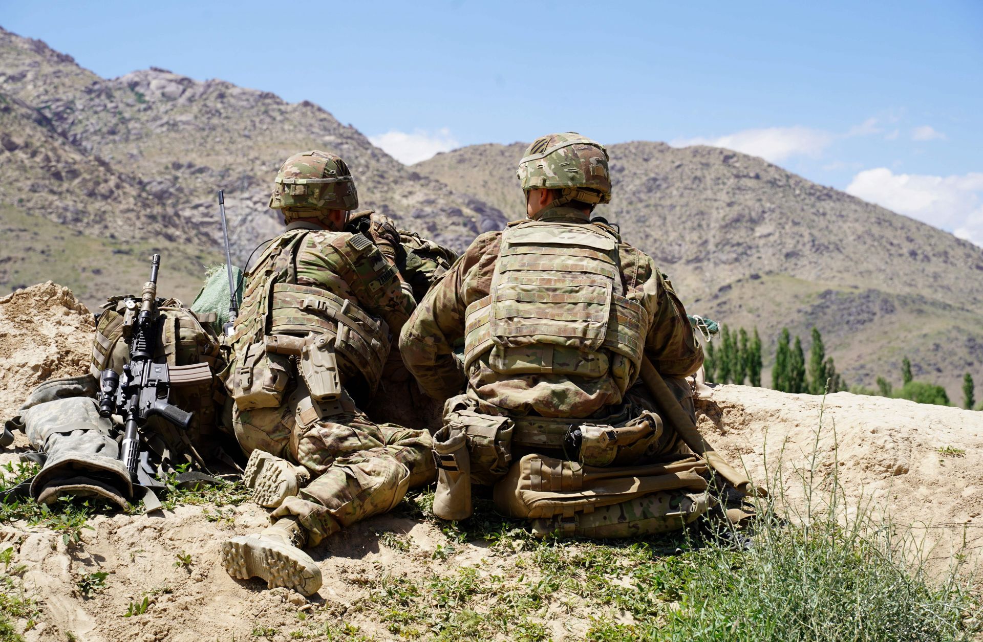 U.S. soldiers look out over the hillsides of an Afghan army checkpoint in Afghanistan's Wardak province on June 6, 2019.
