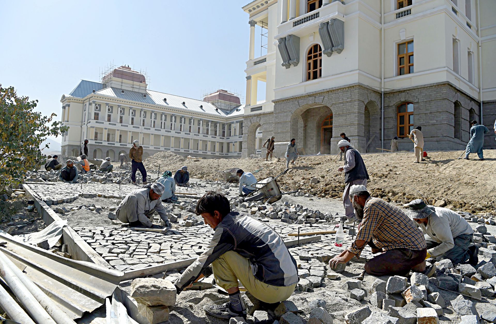 Afghan laborers work on the exterior renovation of Darulaman Palace in Kabul on Aug. 8, 2019.
