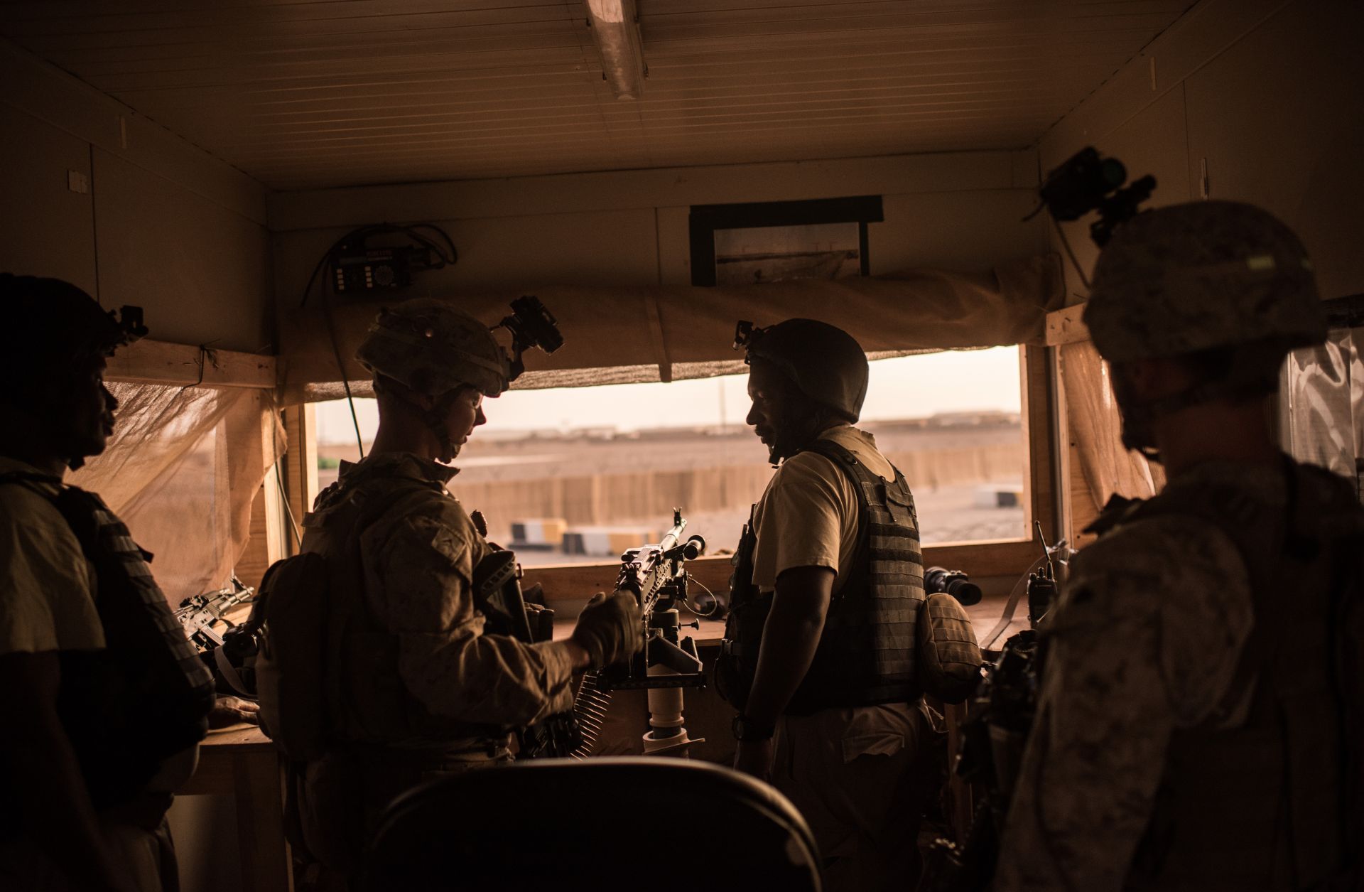 U.S. marines talk to Ugandan contractors at a guard station in Helmand Province, Afghanistan.