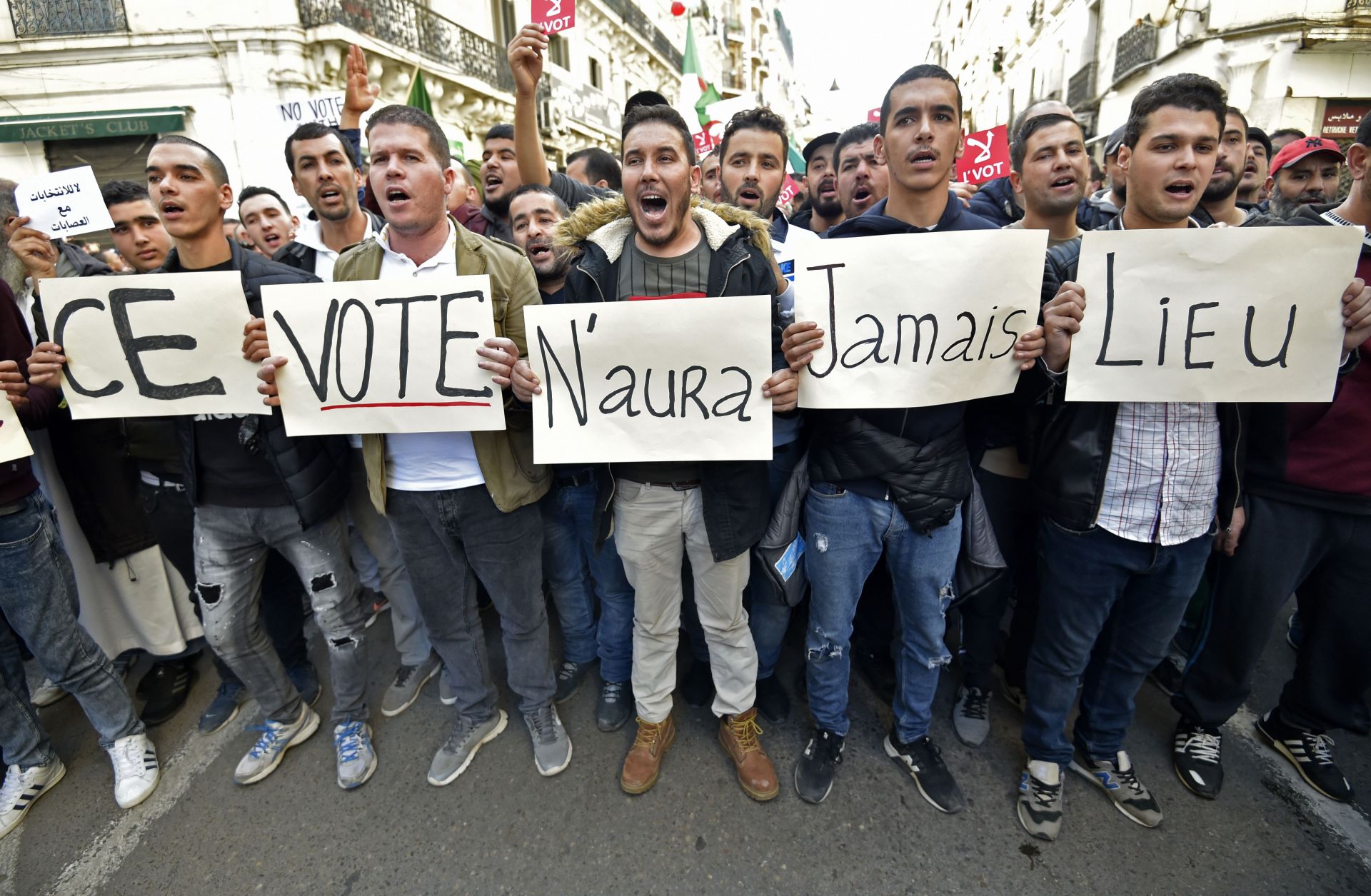 Algerian demonstrators carry placards reading "This vote will never take place" in French in regard to the Dec. 12 presidential election, during a march in Algiers on Dec. 6, 2019.
