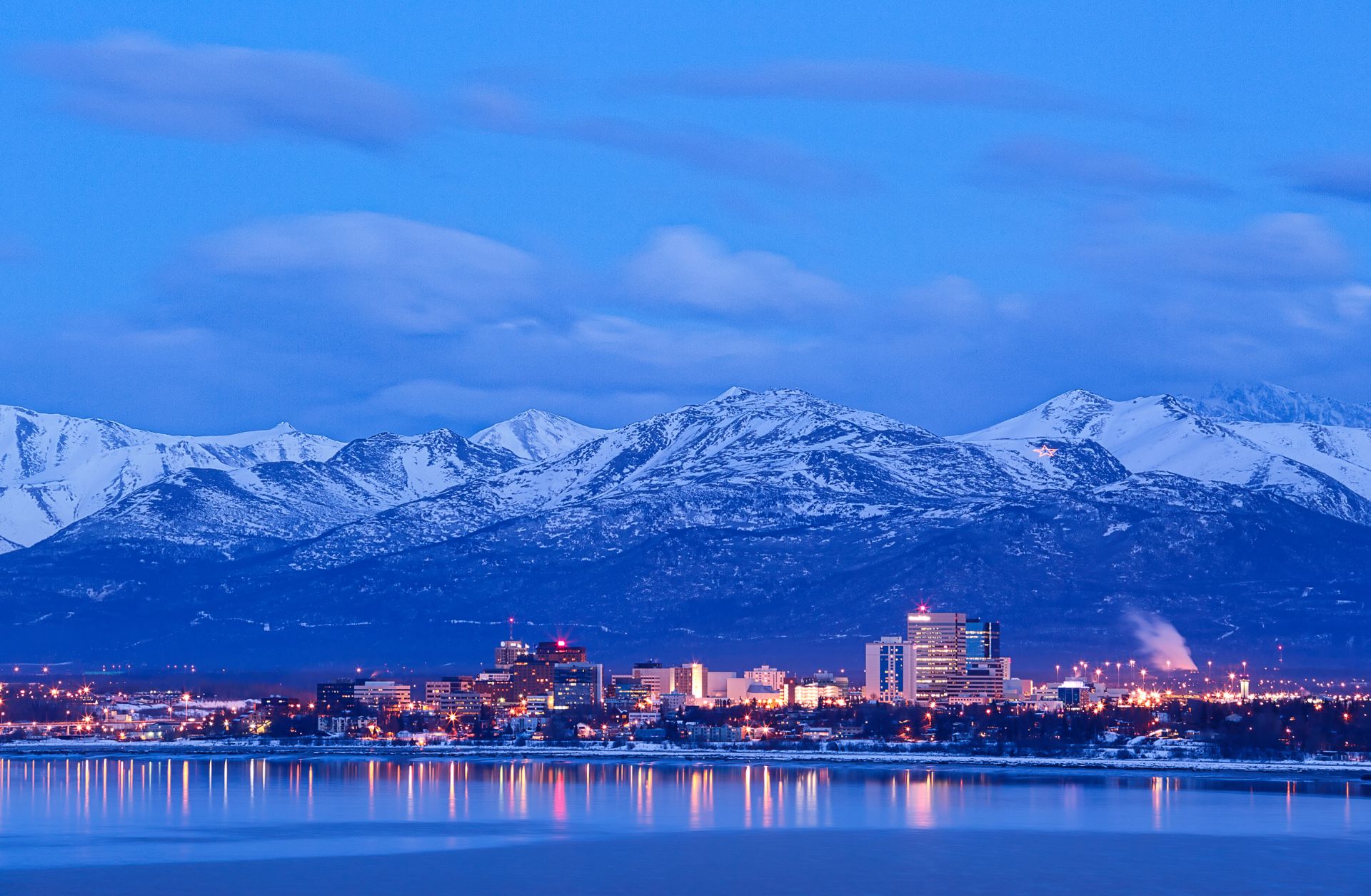 A skyline view of Anchorage, Alaska, and the Chugach Mountains at dusk. A skyline view of Anchorage, Alaska, and the Chugach Mountains at dusk.