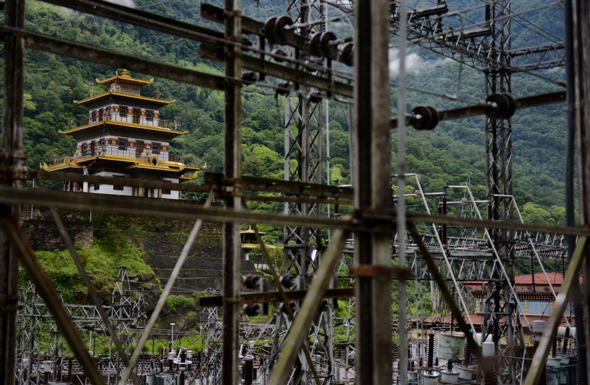 A Buddhist temple sits near a hydroelectric grid main in southeastern Bhutan in 2013.