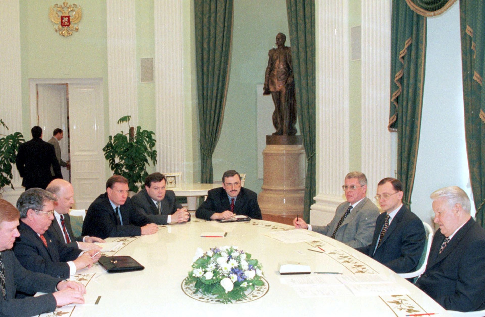 Russian president boris yeltsin sits in a meeting with leading national bankers.