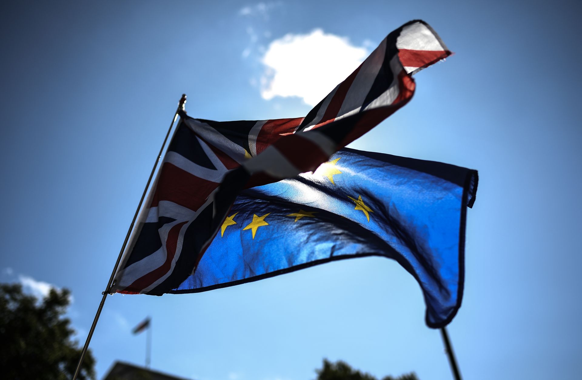 The Union Jack and the European Union flag wave outside the British Cabinet Office in London on Aug. 29, 2019, as protesters rally against Prime Minister Boris Johnson's suspension of Parliament.