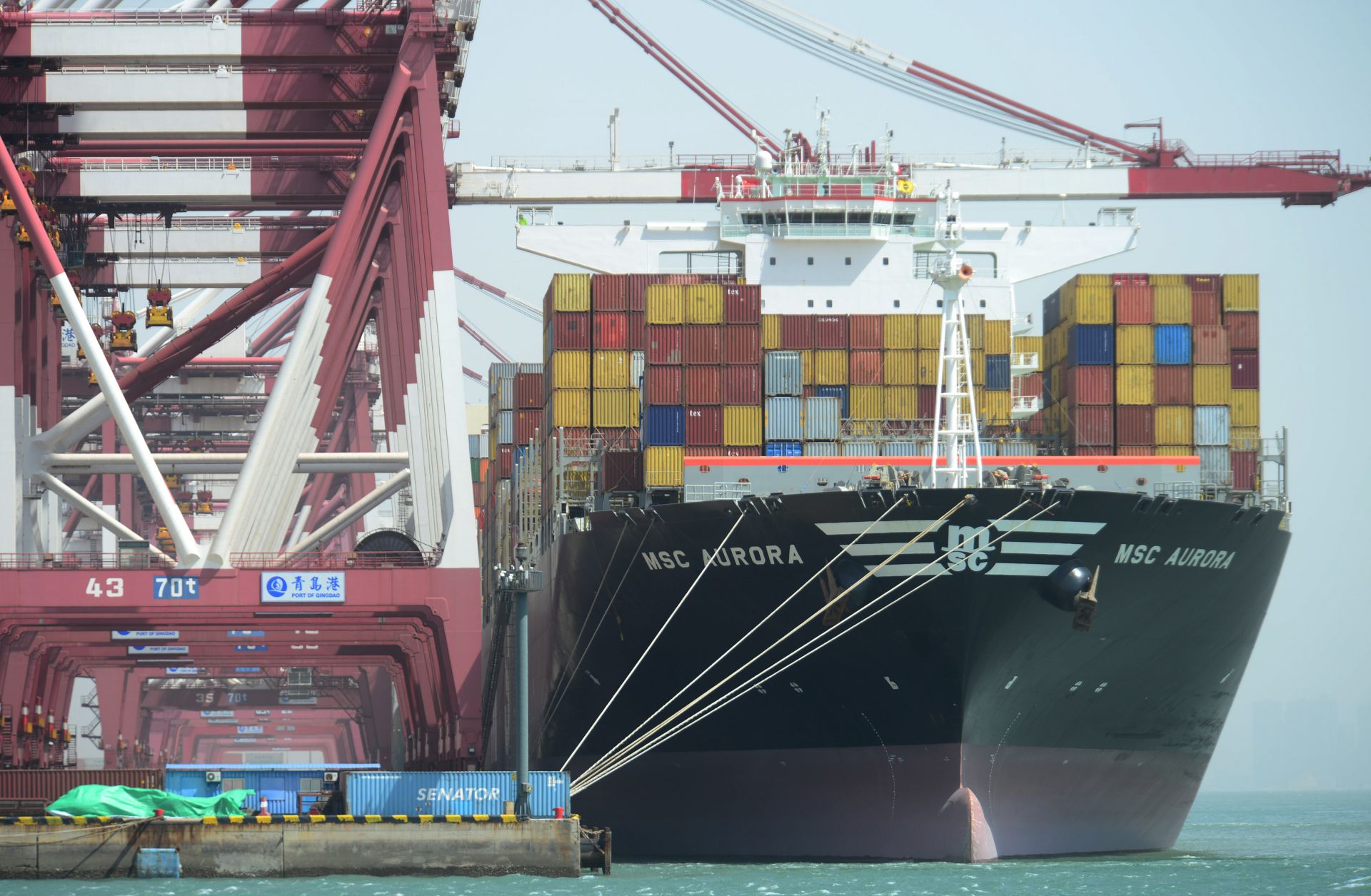 A cargo ship carrying containers stops at Qingdao Port on April 6, 2018, in Qingdao, China. 