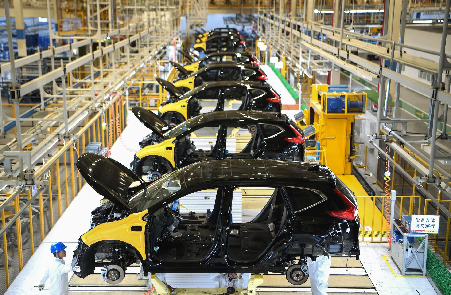 This photo shows workers at Dongfeng Motor's joint venture with Honda in Wuhan, China.