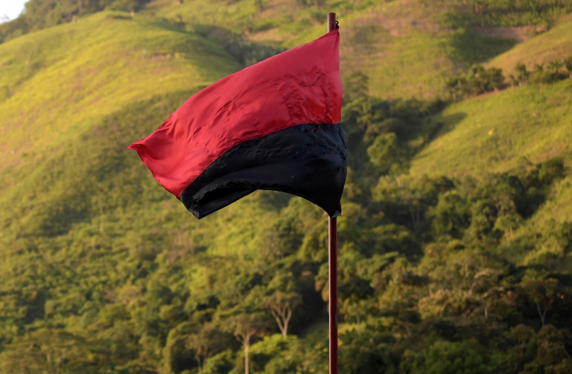 A flag of the National Liberation Army (ELN) guerrilla group flutters in the wind in Catatumbo, Colombia, on Aug. 18, 2022. 