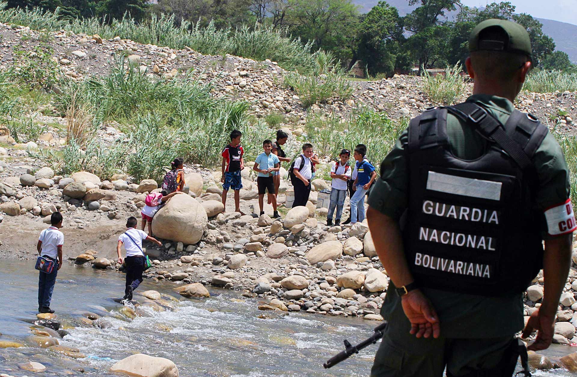 A member of the Venezuelan national guard stands watch at the Tachira River, at the Colombian border. Criminal activity, driven in part by smuggling, will persist in parts of the border region.