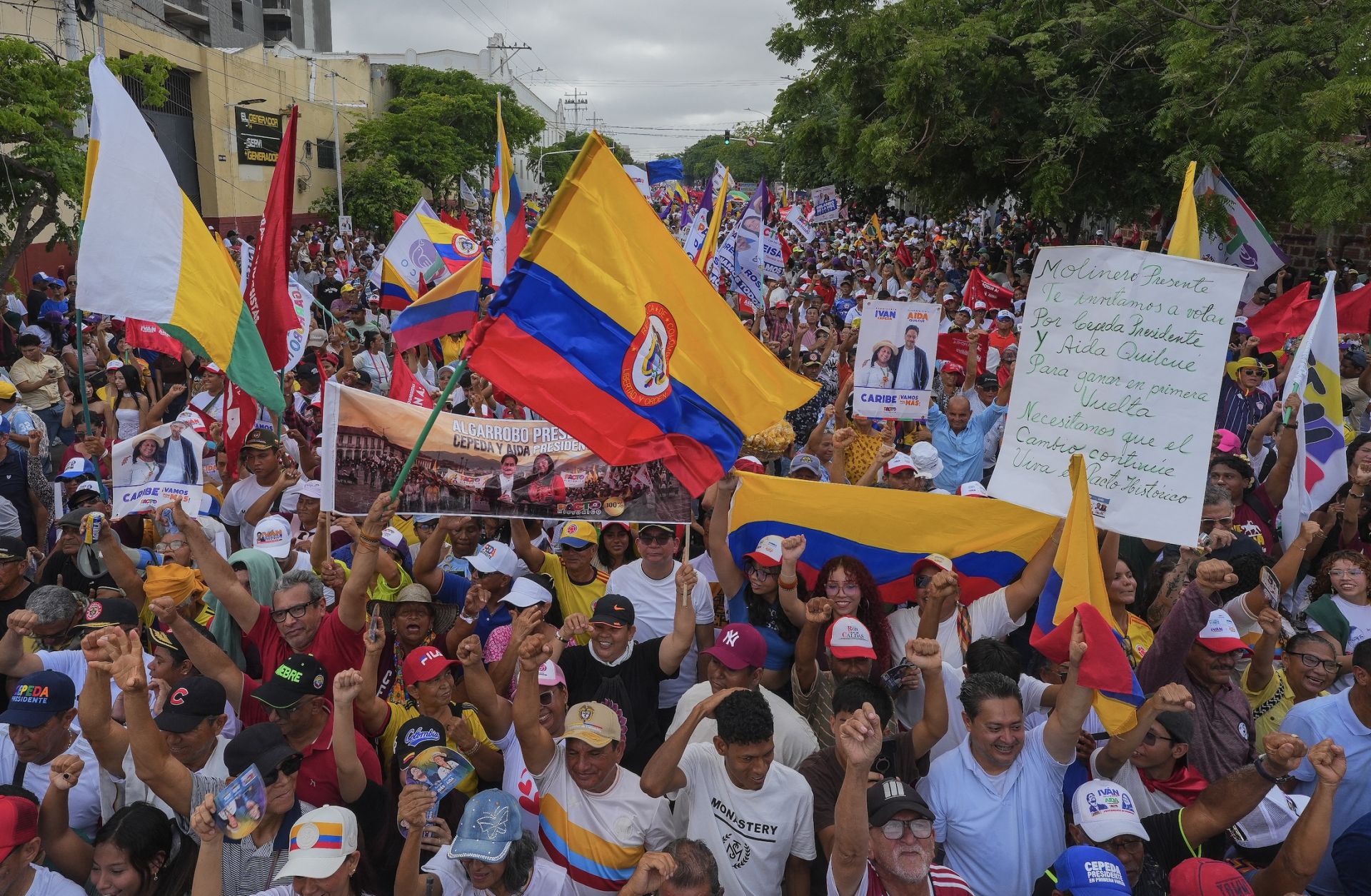 Supporters of Colombian presidential candidate Ivan Cepeda wave flags ahead of his closing campaign rally in Barranquilla, Colombia, on May 24, 2026.