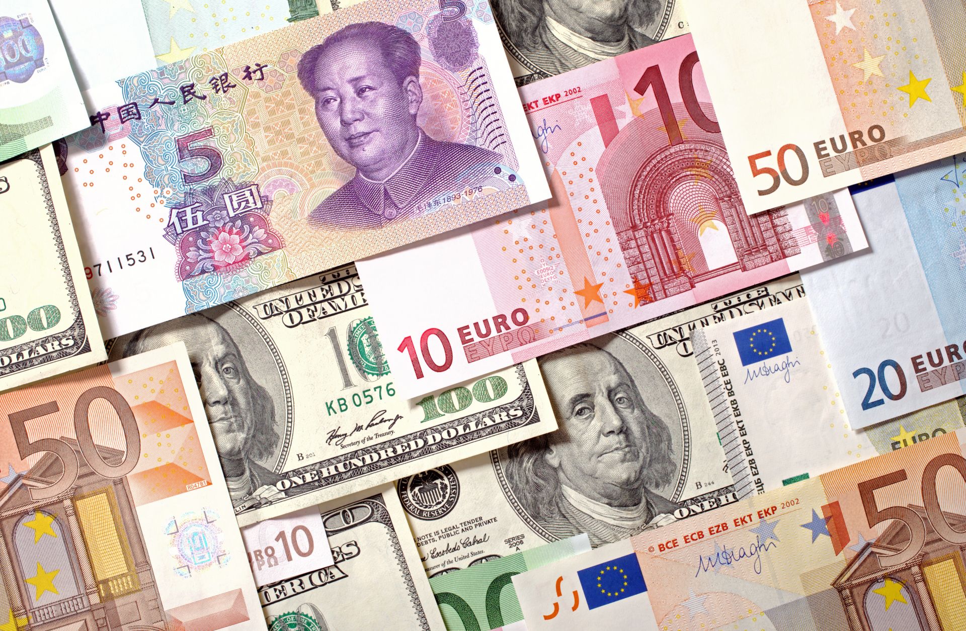 This photo illustration displays currencies of China, the European Union and the United States.