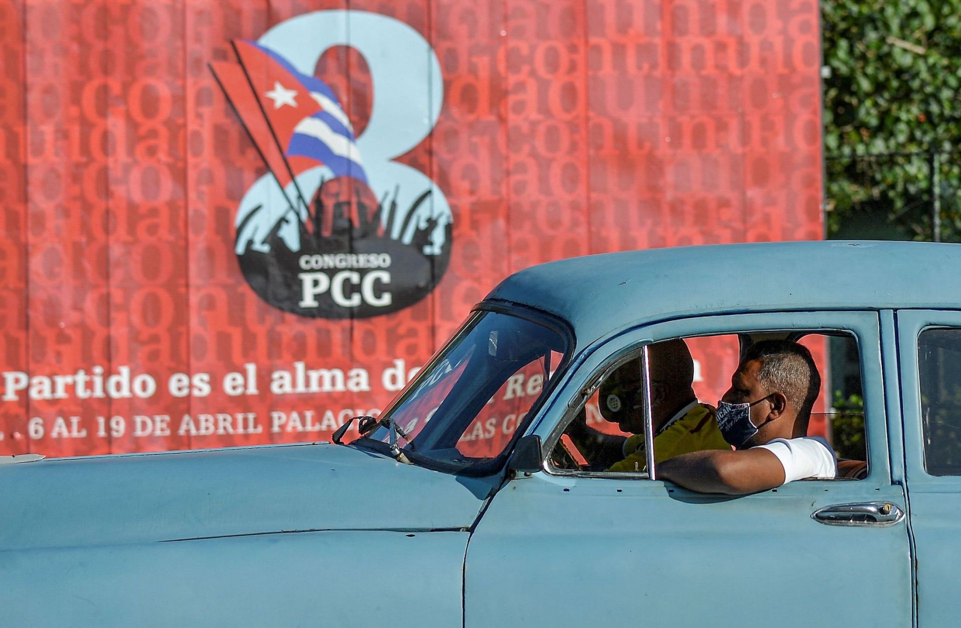 A motorist passes a sign for the 8th Congress of the Cuban Communist Party on April 6, 2021, in Havana.