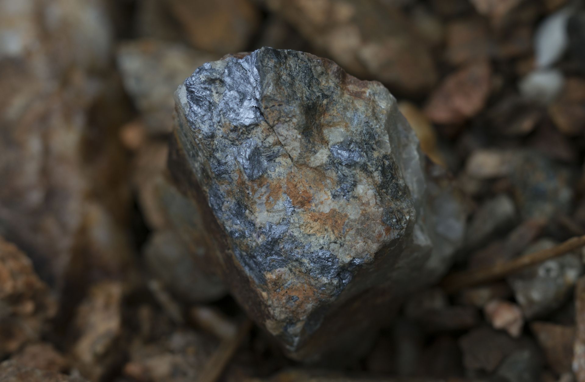 Dark colored mineral Molybdenite and the metal contained within the mineral called Molybdenum.