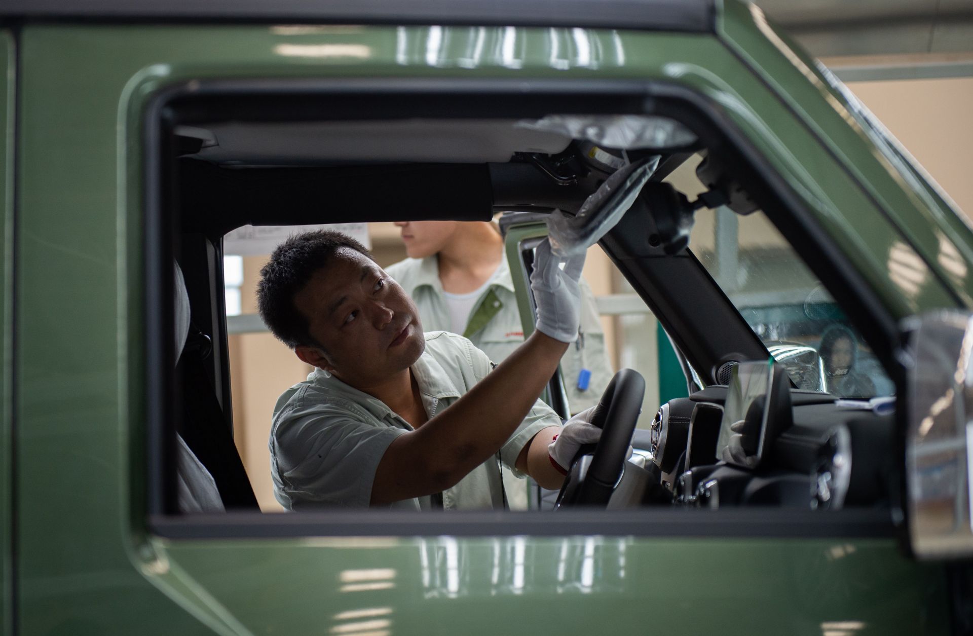 A Chinese autoworker is pictured on an SUV production line for the BAIC Motor Corp. on Aug. 29, 2018.