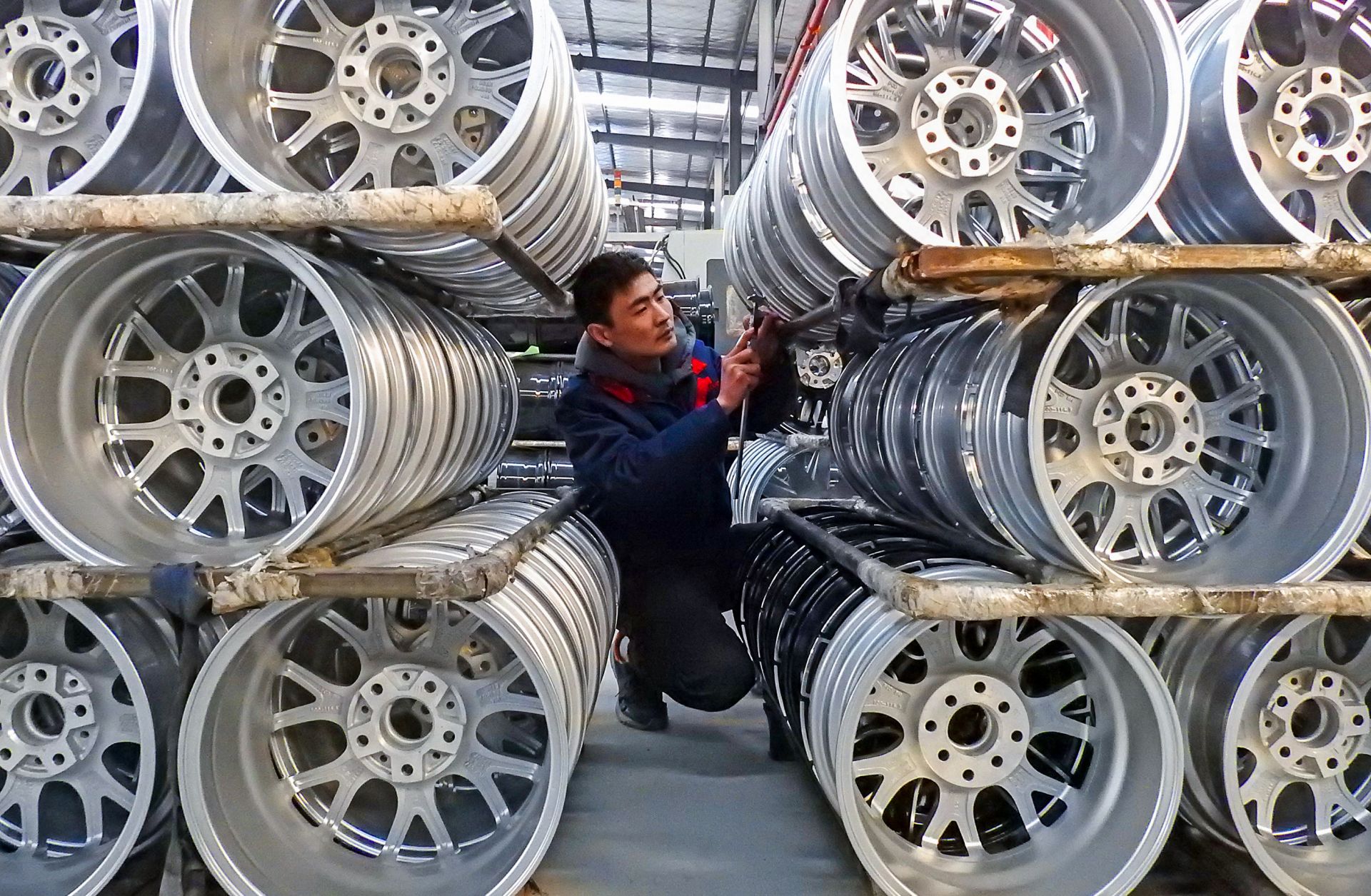 A Chinese worker checks wheels on Jan. 28, 2019, at a factory in Lianyungang, Jiangsu province.