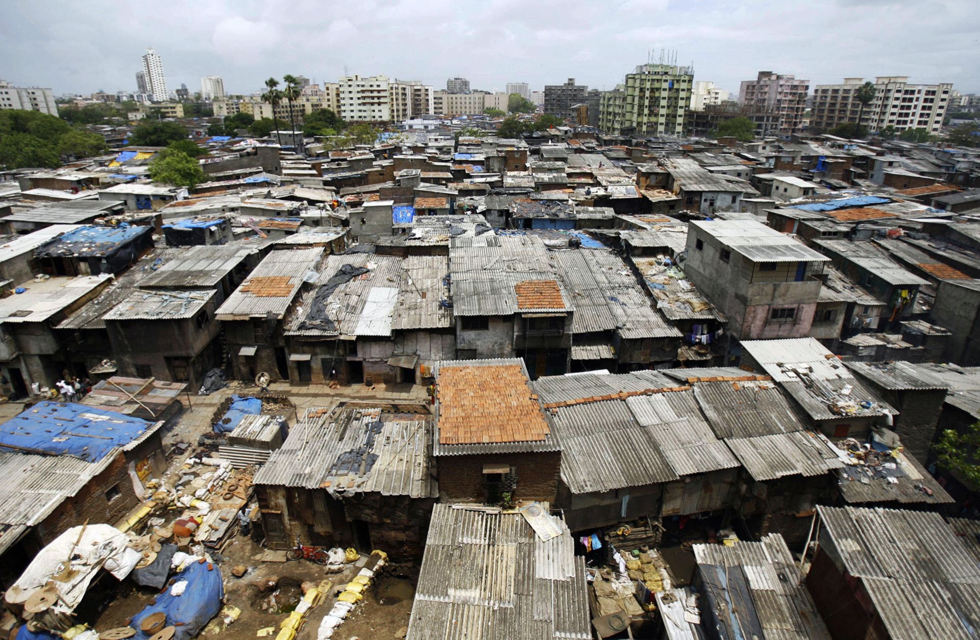 In this 2007 photograph, office blocks and residential buildings tower over the notorious slum colony of Dharavi in Mumbai, India.