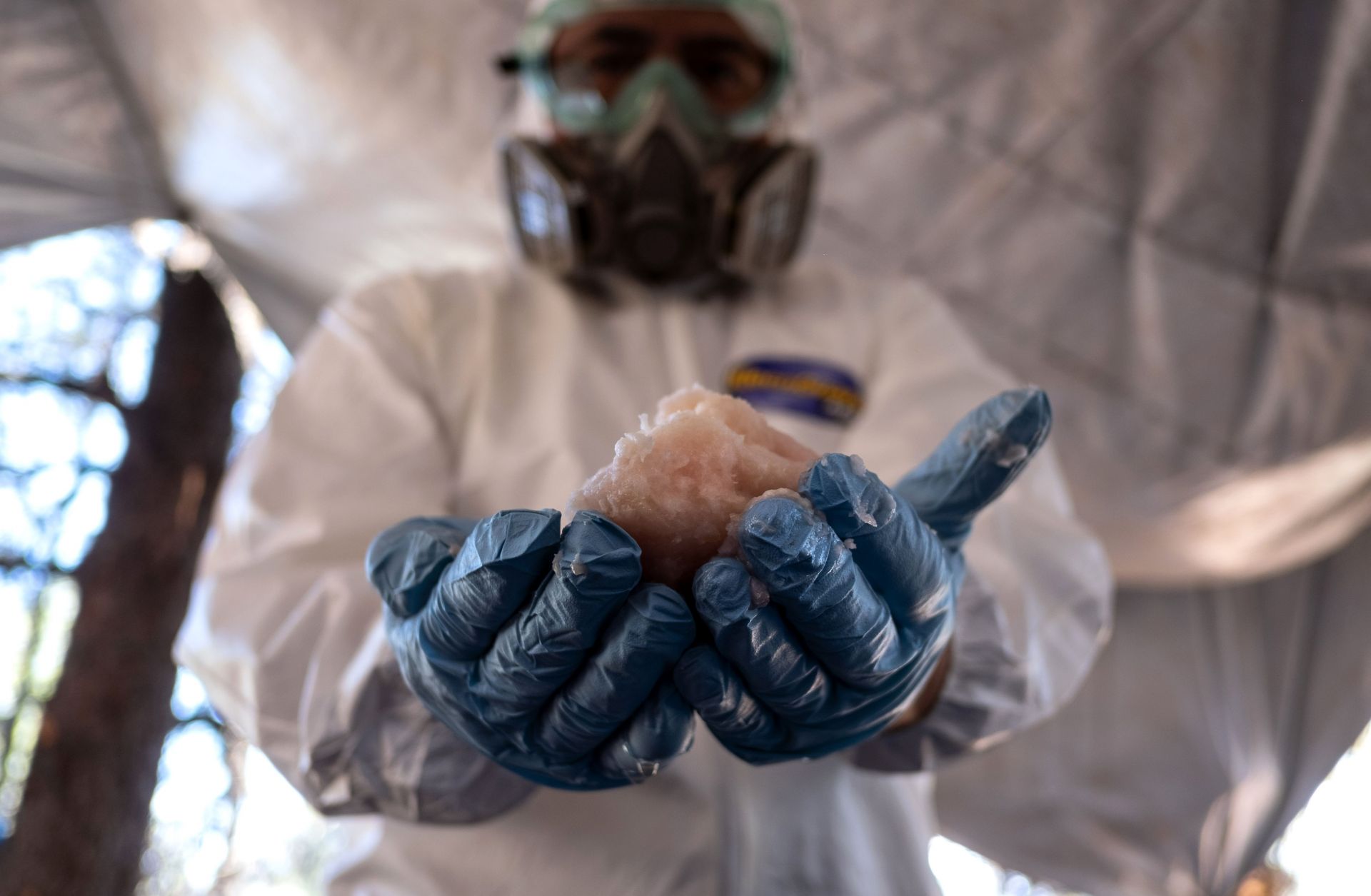A Mexican Army expert in protective gear displays crystal meth paste at a clandestine laboratory near la Rumorosa town in Tecate, Baja California state, Mexico on Aug. 28.