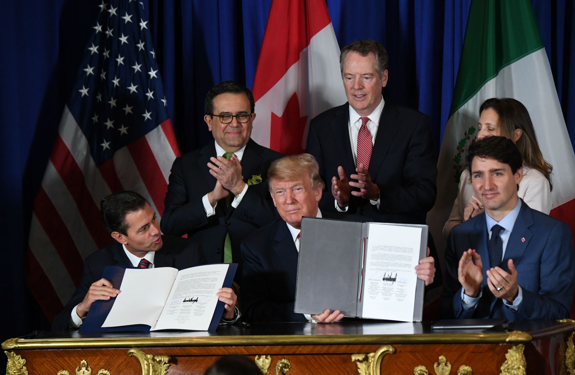Mexican President Enrique Pena Nieto (left), U.S. President Donald Trump (center) and Canadian Prime Minister Justin Trudeau sit together after signing a new free trade agreement in Buenos Aires, Argentina, on Nov. 30.