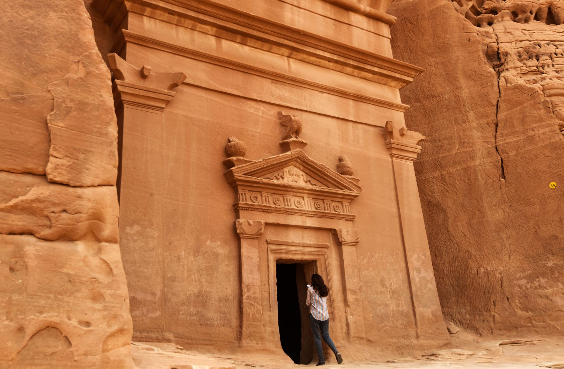 A journalist takes a picture of a tomb at Madain Saleh, a UNESCO World Heritage site, in Saudi Arabia's northwest on March 31, 2018.