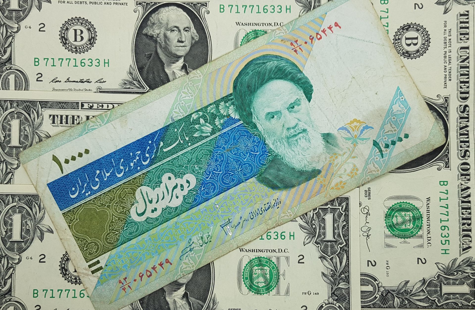 This photo shows 10,000 Iranian rials on top of U.S. dollars.