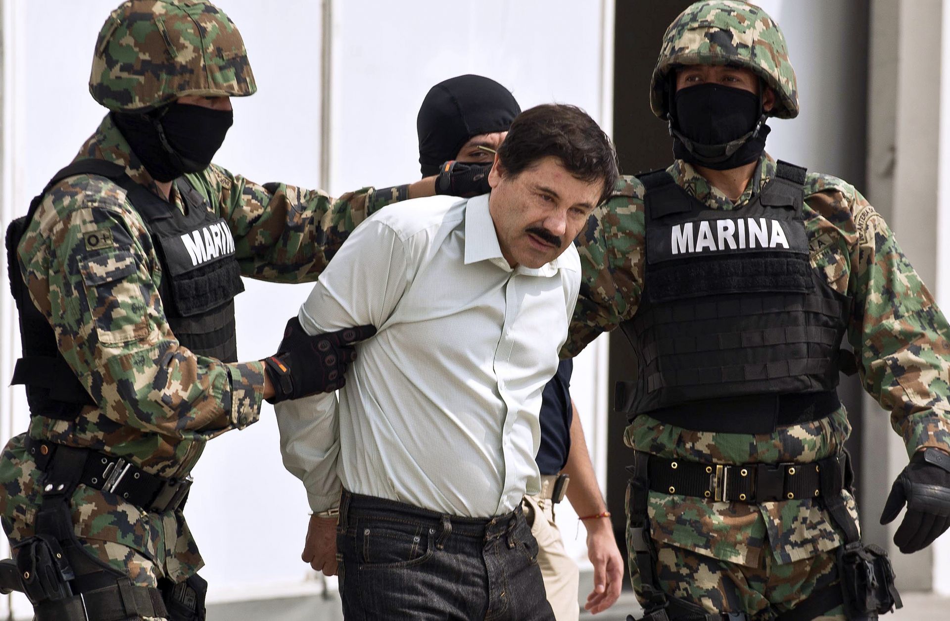 Mexican drug trafficker Joaquin Guzman Loera, aka "el Chapo Guzman" (C), is presented to the press on Feb. 22, 2014 in Mexico City.