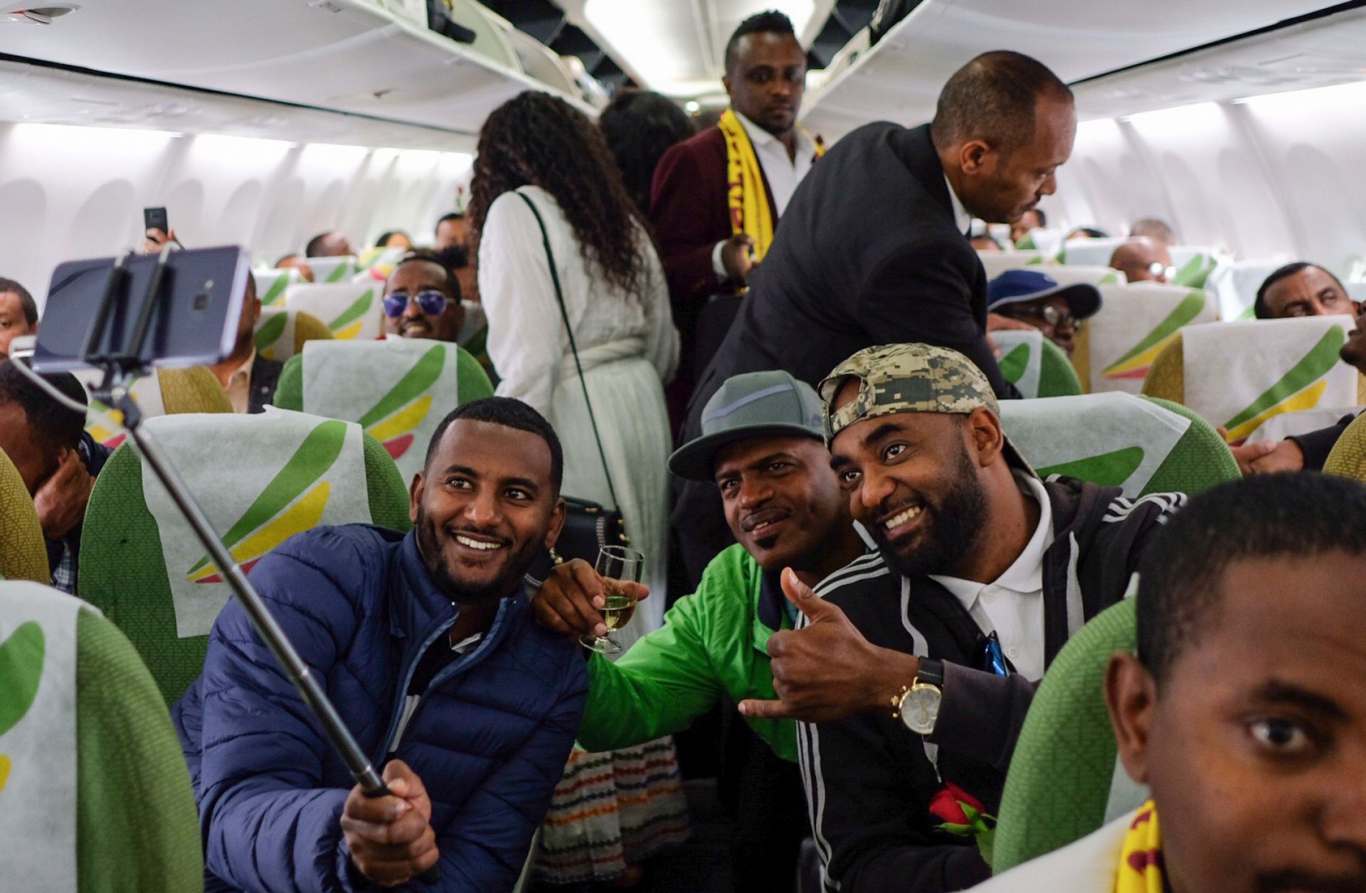 Passengers pose for a selfie inside an Ethiopian Airlines flight on July 18, 2018. The trip was the first commercial flight between the Ethiopian and Eritrean capitals in two decades.