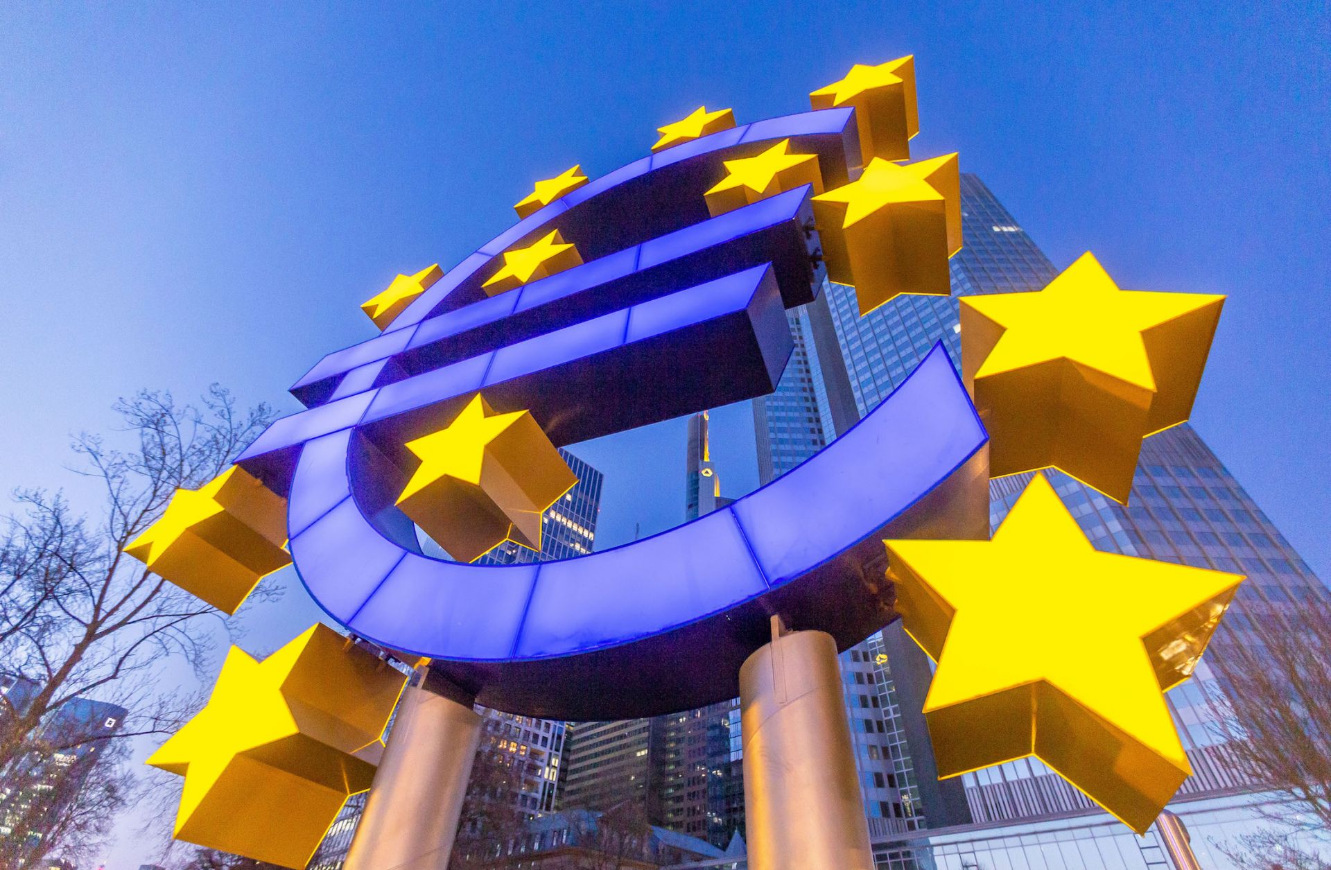 A statue of the euro logo is seen in front of the European Central Bank building in Frankfurt, Germany, on March 27, 2020. 