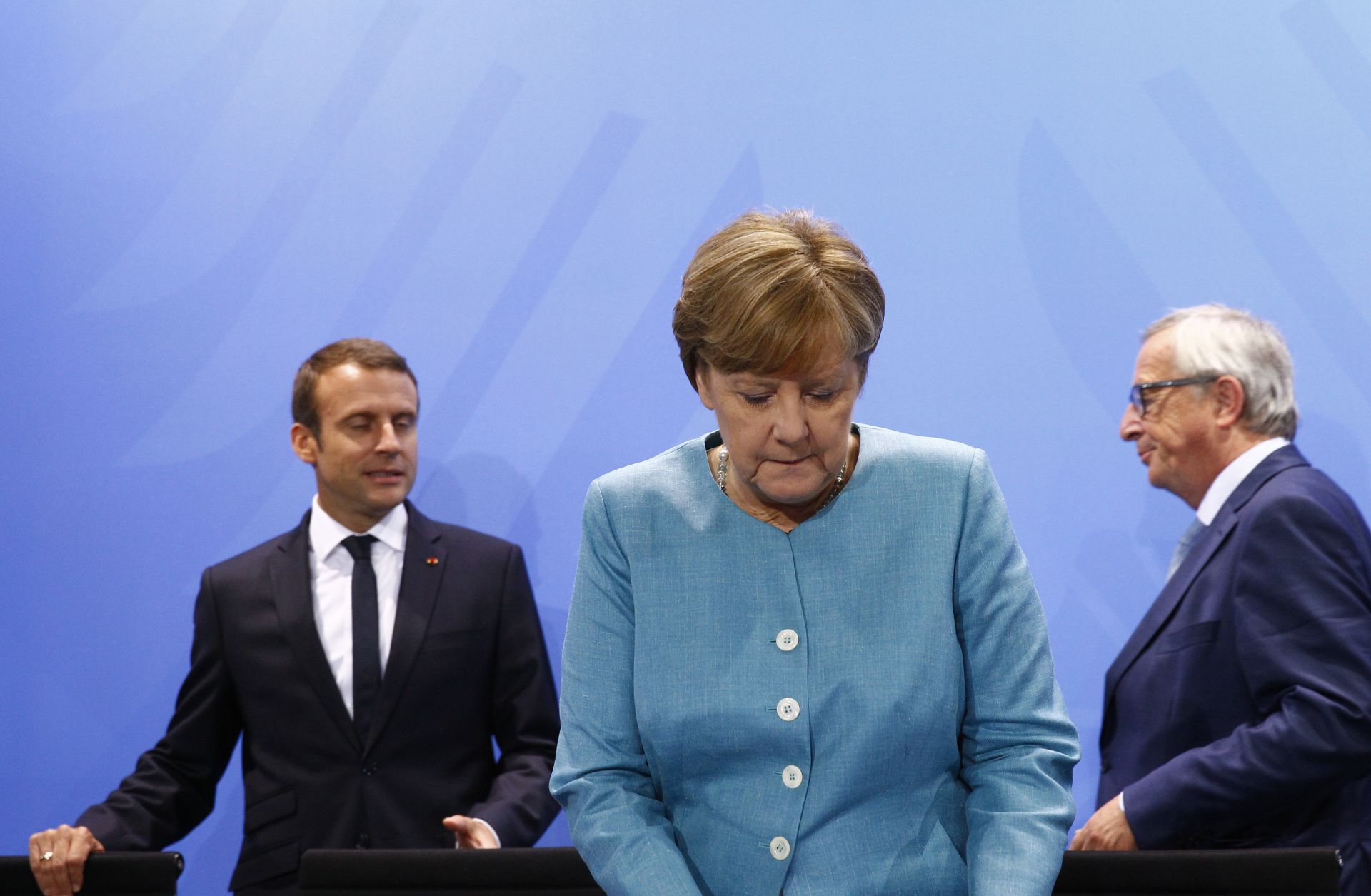 German Chancellor Angela Merkel, French President Emmanuel Macron and European Commission President Jean-Claude Juncker gather for a press conference after a June 29 meeting of EU leaders in Berlin.