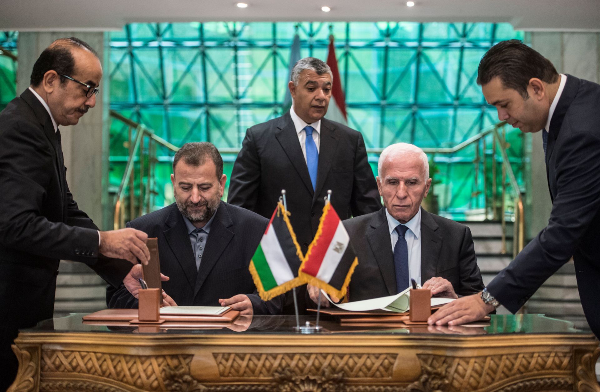The leaders of Fatah and Hamas sign a reconciliation deal at the Egyptian intelligence services headquarters in Cairo on Oct. 12, ending their decadelong split.