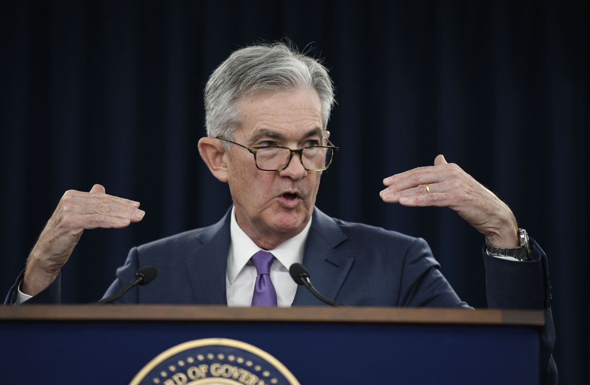 This image shows Jerome Powell, chairman of the U.S. Federal Reserve, delivering news about the central bank's decision to cut its benchmark interest rate.