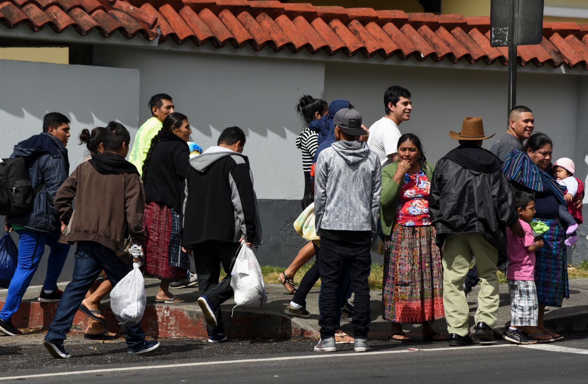 Migrants deported from the United States stand outside an air force base in Guatemala City on Dec. 12, 2019.