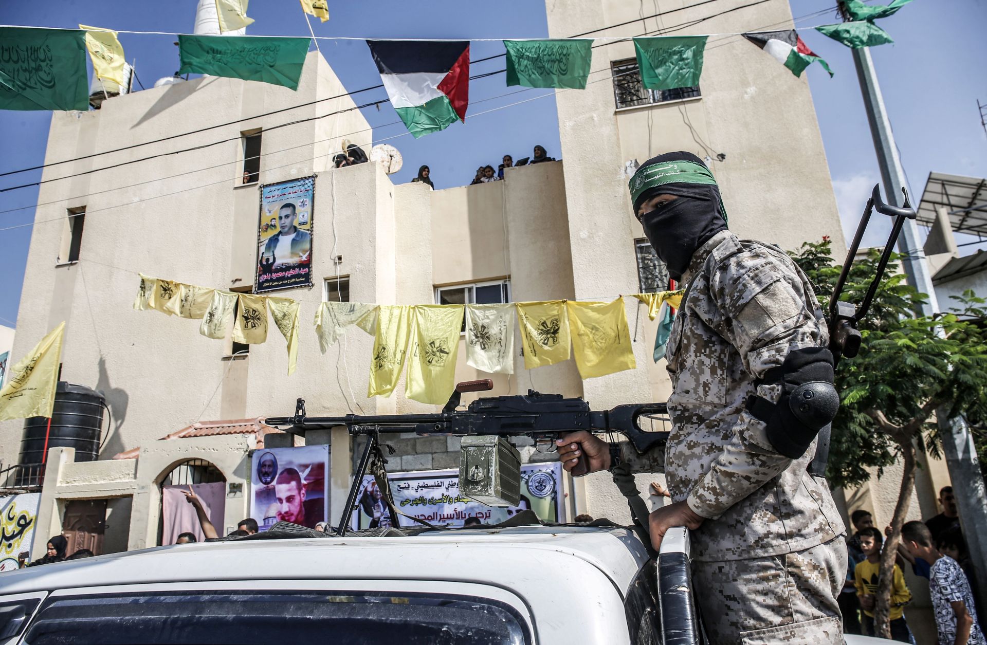 A masked Hamas militant mans a machine gun in the back of a pickup truck in the Palestinian city of Rafah, located in the southern Gaza Strip, on Oct. 17, 2019. The yellow flags of the Palestinian party Fatah can also be seen in the background. A masked Hamas militant mans a machine gun in the back of a pickup truck in the Palestinian city of Rafah, located in the southern Gaza Strip, on Oct. 17, 2019. The yellow flags of the Palestinian party Fatah can also be seen in the background.