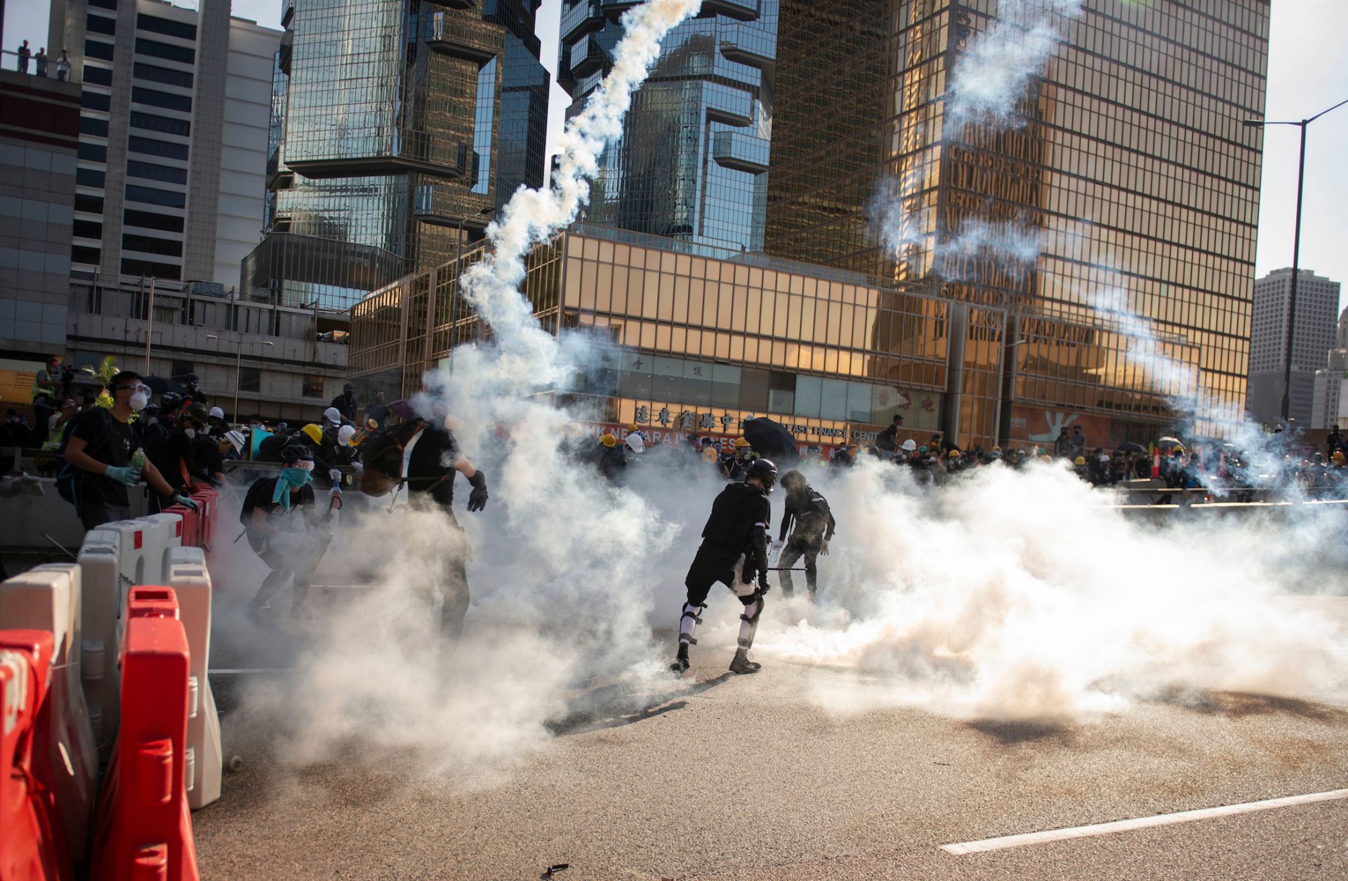 Protesters fleeing tear gas during a general strike in Hong Kong in August 2019. With rising international efforts to constrain China's economic and political rise, Beijing cannot allow Hong Kong, a Chinese city, to remain a challenge to central authority. Protesters fleeing tear gas during a general strike in Hong Kong in August 2019.