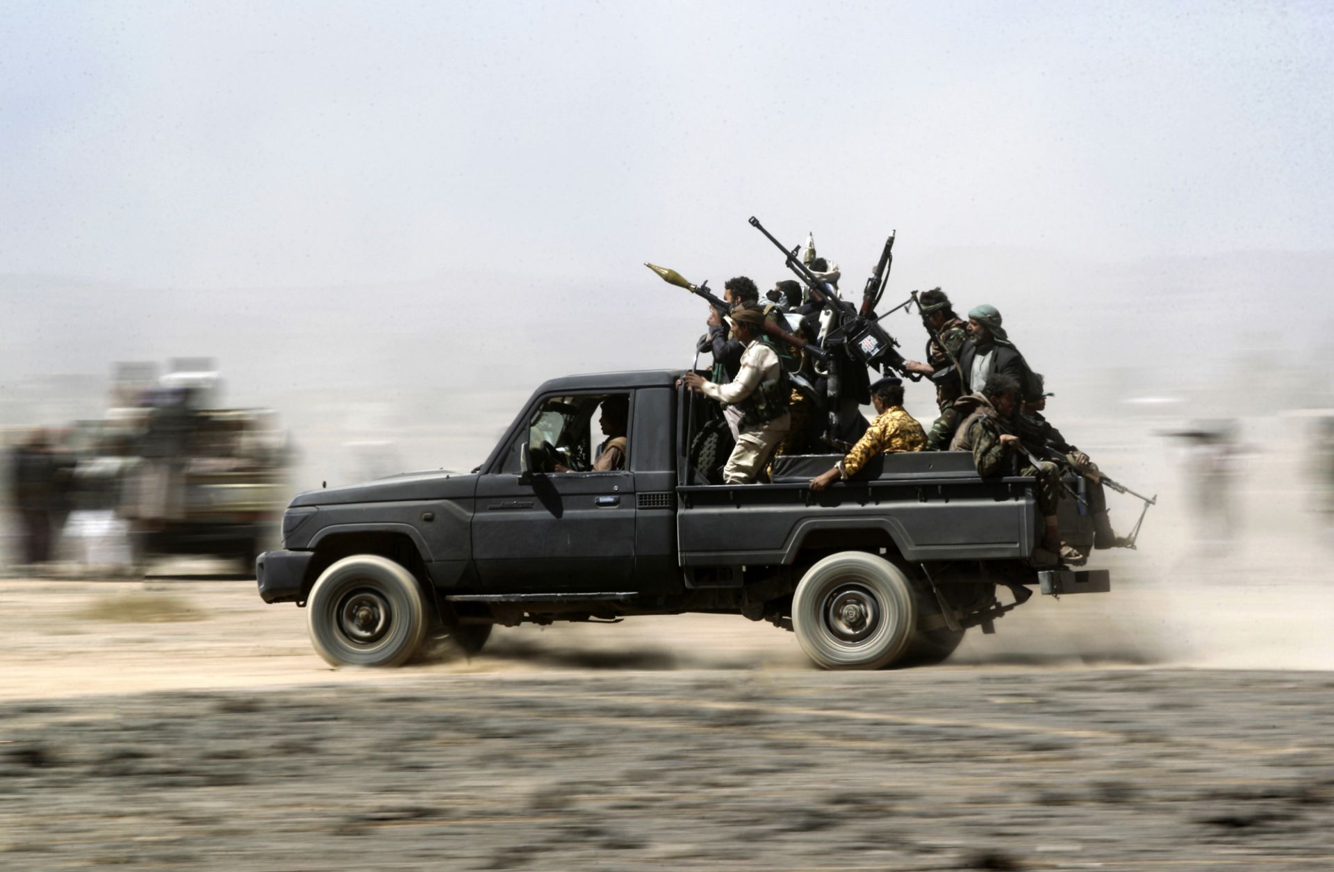 Tribesmen loyal to the Houthis ride in the back of a vehicle during a gathering to mobilize more fighters on Nov. 1, 2016, on the outskirts of Sanaa, Yemen.