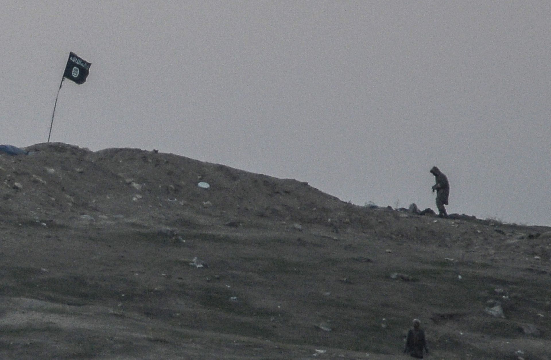 Militants of Islamic State are seen just before the explosion of airstrike on Tilsehir hill near the Turkish border on Oct. 23, 2014, at Yumurtalik village, in Sanliurfa province. 