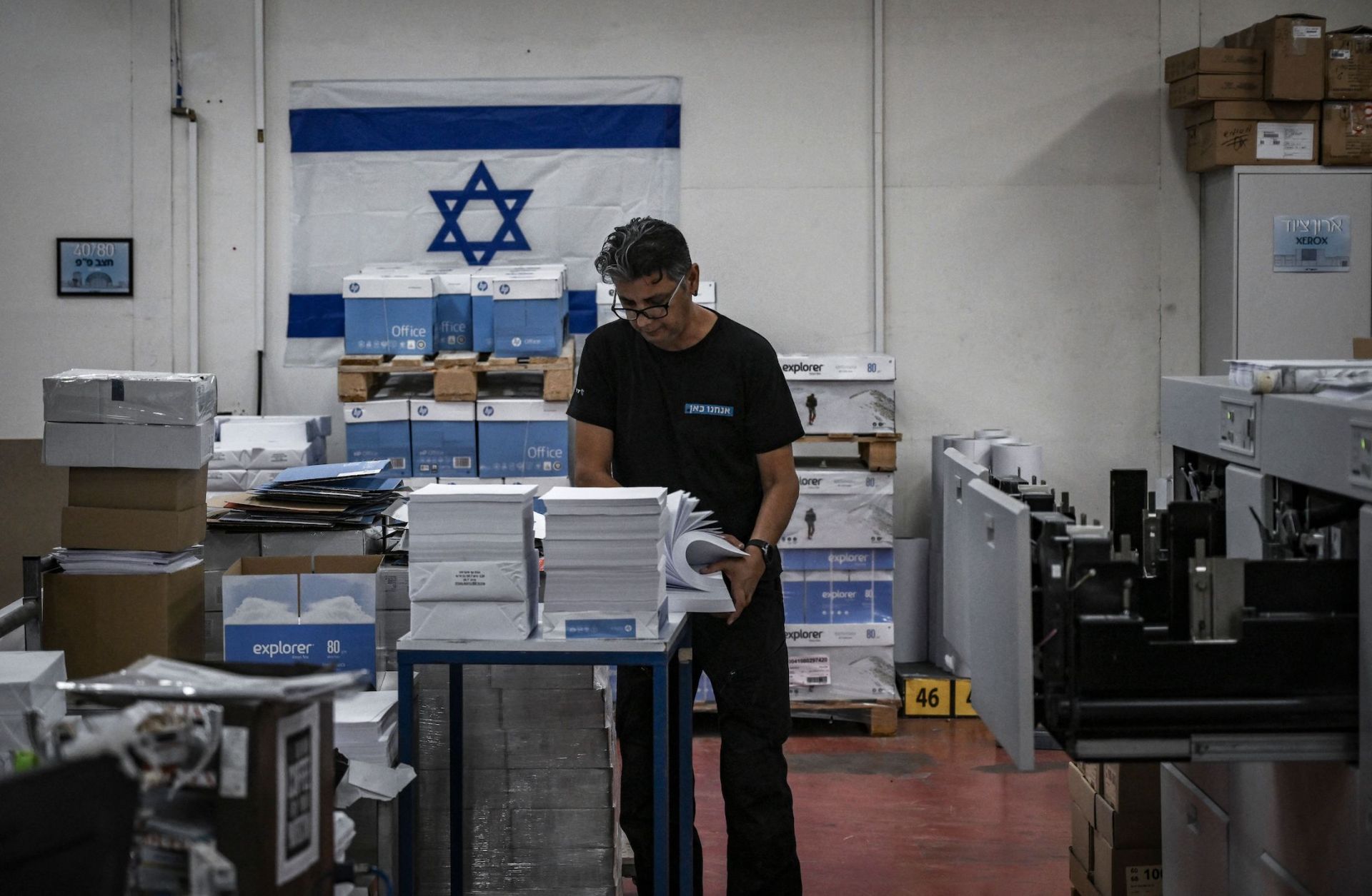A photo taken on Nov. 5, 2023, shows a man working at a printing factory in southern Israel that recently resumed business following Hamas' Oct. 7 assault. 