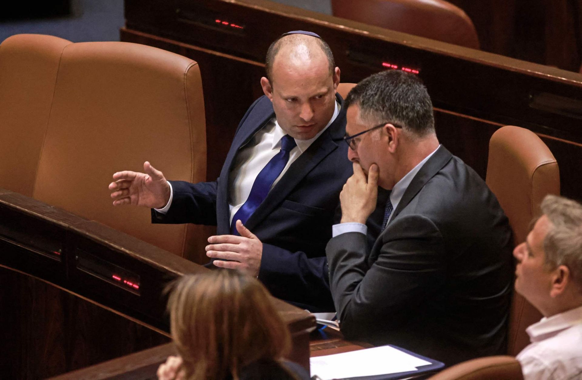 Israeli Prime Minister Naftali Bennett (left) speaks with Justice Minister Gideon Sa’ar in the Knesset on June 16, 2021. 
