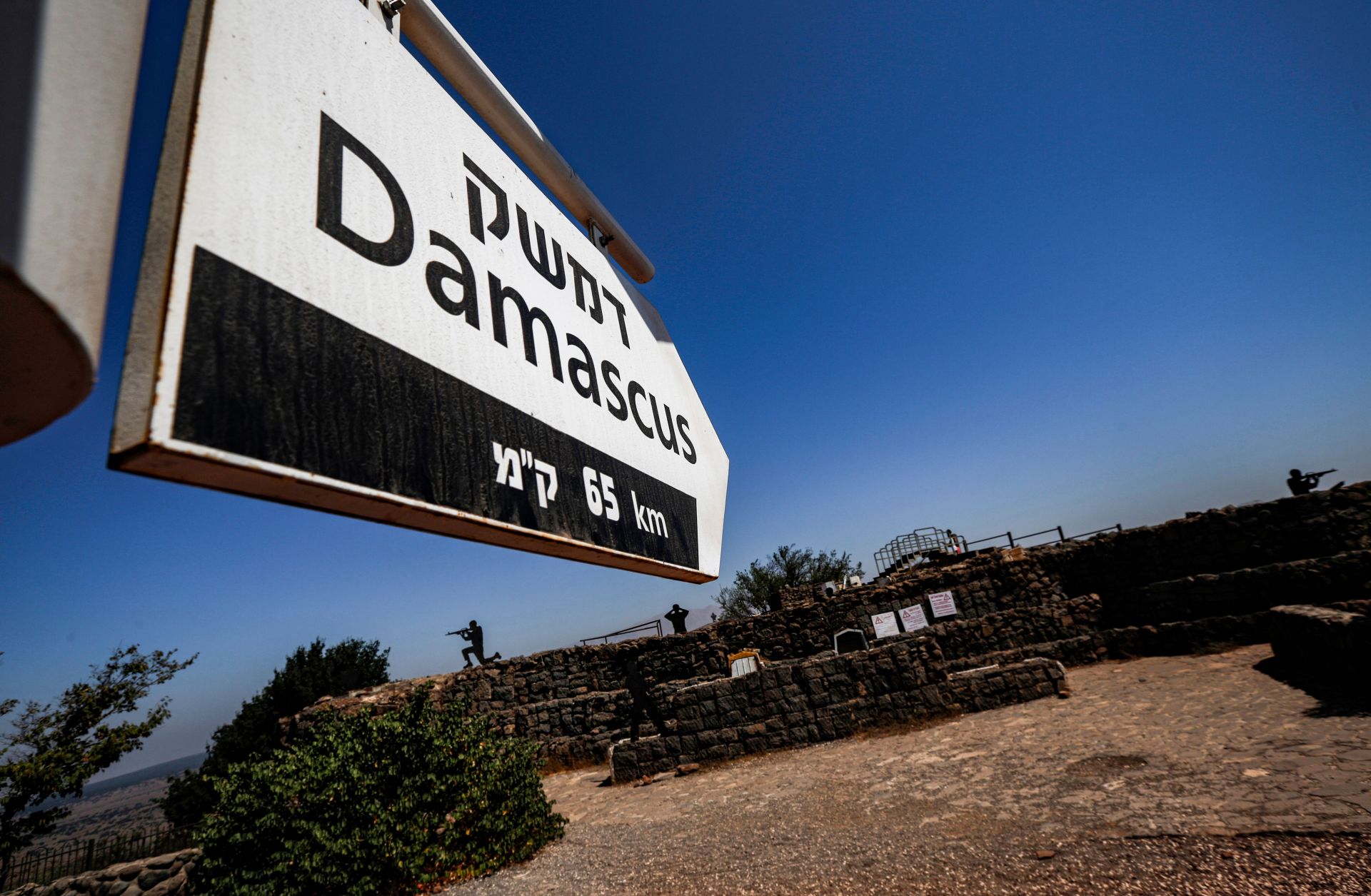 This picture taken on Aug. 25, 2019, from a tourist lookout point at an Israeli army outpost on Mount Bental in the Israeli-annexed Golan Heights shows a directional sign for Damascus.